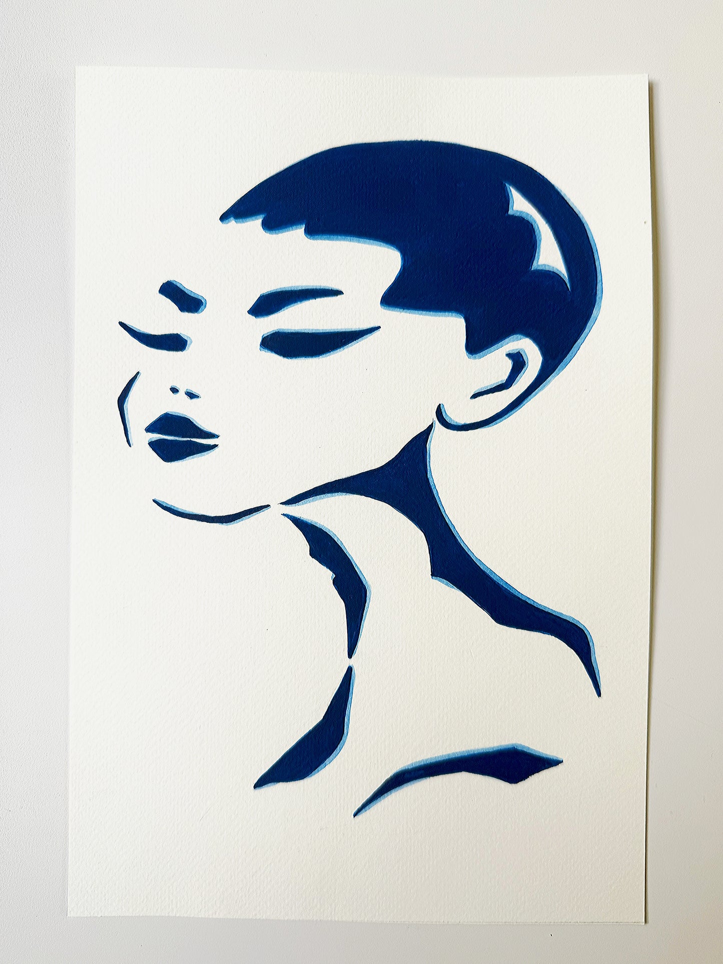 Blue silhouette of a woman's face artwork on a white background