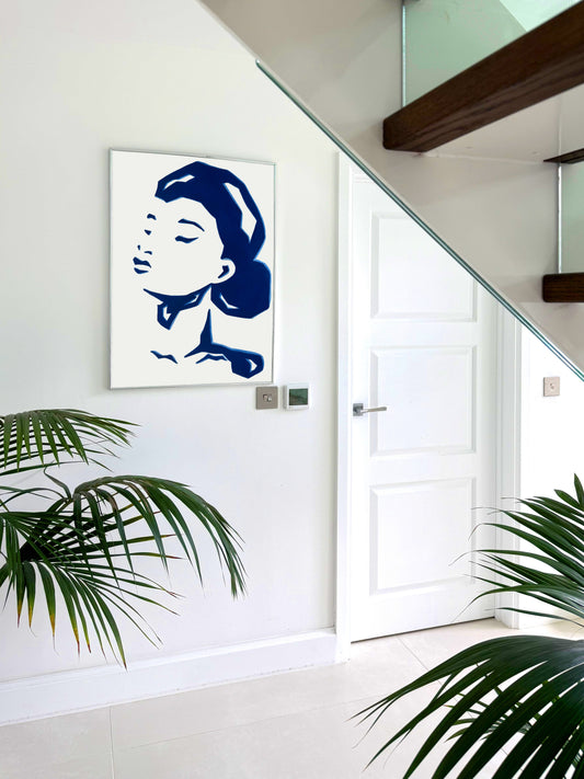 Modern abstract  artwork of a female portrait on a white wall.