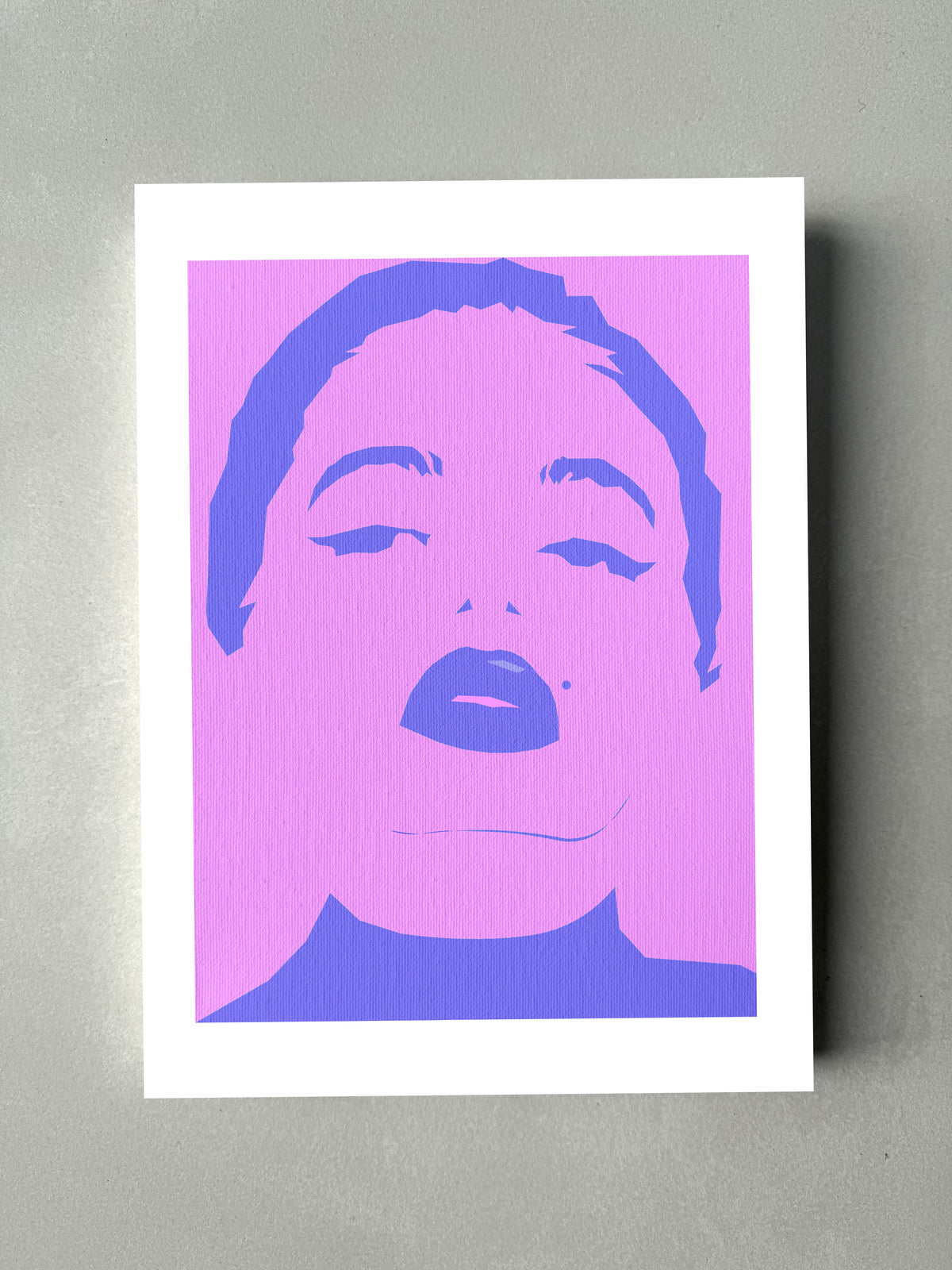 A female blue face portrait on a pink background textured paper. Pop art. Minimalist art. Fashion art.